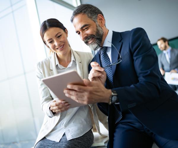 Two businesspeople looking at tablet