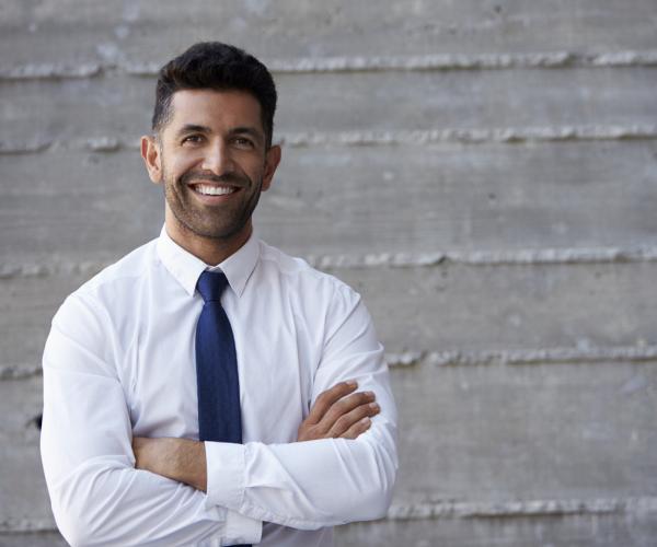 Businessman standing against a wall