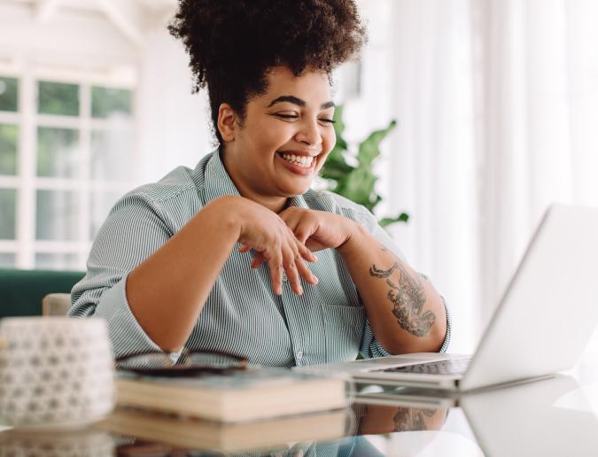 Smiling woman looking at her laptop